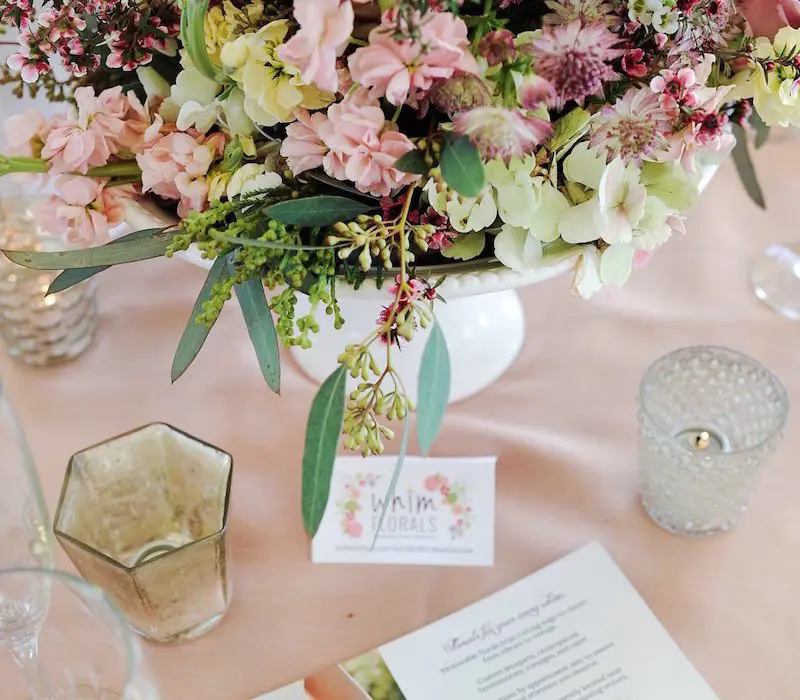 A table with flowers and cards on it
