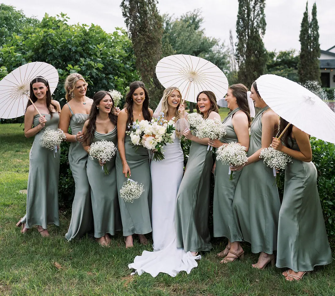 Bride and bridesmaids in sage green gowns.